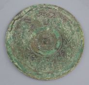 A Chinese bronze circular mirror, Western Han dynasty, 2nd century B.C. cast in low relief with