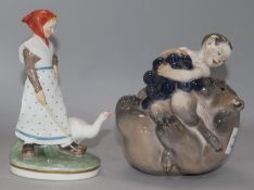 A Royal Copenhagen model of a faun with a bear and grapes and a figure of a girl with a goose (2)