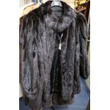 A dark brown mink coat with shoulder tail detail