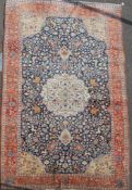 An Isfaphan blue ground carpet, with field of scrolling foliage and three row border, 15ft 10in by