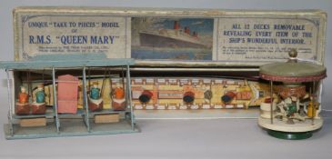 A boxed Queen Mary model and two miniature wooden fairground toys