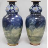 A pair of Royal Doulton double gourd vases, each having lower baluster section glazed in dark blue