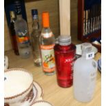 Six bottles of assorted spirits including Grey Goose and Absolut flavoured vodka and Old Krupnik