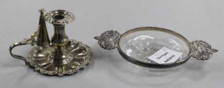 A George V silver mounted 2 handled glass dish and a plated chamberstick.