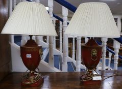 A pair of Regency style red and gilt lamp bases 38cm to fitting