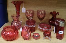 Twelve items of cranberry glassware, to include a vine-engraved beaker, a pair of floral-engraved