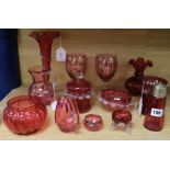 Twelve items of cranberry glassware, to include a vine-engraved beaker, a pair of floral-engraved