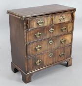 A George III mahogany bachelor's chest, with folding top over two short and three graduated long