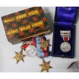 A group of four WWII medals and a silver medal etc