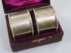 A cased pair of Victorian silver serviette rings, London, 1890.