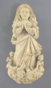 A Goanese ivory figure of the Virgin Mary, 17th / 18th century, standing on a scrolled plinth with