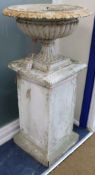 A pair of Victorian cast iron composition urns W.55cm