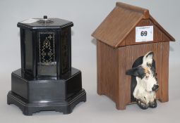 A bakelite musical cigarette dispenser and a similar pottery 'kennel' 21cm.