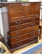 A Victorian mahogany two door cupboard, fitted 4 long drawers W.92cm