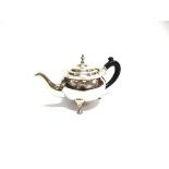 AN EDWARDIAN SILVER TEAPOT maker J.A., London 1903, of globular form with cut cape rim and on four