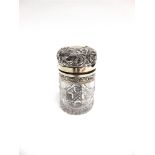 A LATE VICTORIAN SILVER MOUNTED CUT GLASS TOILET BOTTLE London 190, the clear hob nail cut