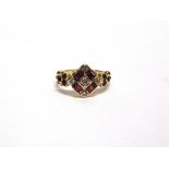 AN 18 CARAT GOLD DIAMOND AND RUBY RING the central diamond enclosed by four square cut rubies and