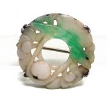 A JADE BROOCH the foliate carved circle approximately 2.6cm diameter