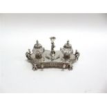 A VICTORIAN ELECTROPLATED STANDISH unmarked, the rectangular shaped stand on claw and ball