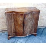 A MAHOGANY SERPENTINE FRONTED SIDE CABINET fitted with two shaped shelves and raised on bracket