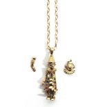 A 9 CARAT GOLD STONE SET CLOWN PENDANT with articulated limbs, on a 9 carat gold chain; with a