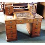 A VICTORIAN WALNUT 'DICKENS' DESK the top fitted with slope flanked by two sets of four shallow