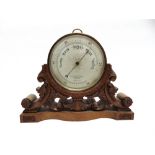 AN ANEROID BAROMETER the silvered dial inscribed 'S & J Hicks HATTON GARDEN LONDON' 21cm diameter,
