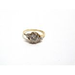A THREE STONE DIAMOND RING stamped ;18ct', the old mine cut stone of approximately 1.25 carats,