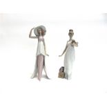 TWO LLADRO FIGURES OF LADIES one holding a puppy, the other with a wide brimmed hat, both approx
