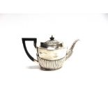 A LATE VICTORIAN SILVER BACHELOR TEAPOT makers mark rubbed, Chester 1900, of oval gadrooned form,