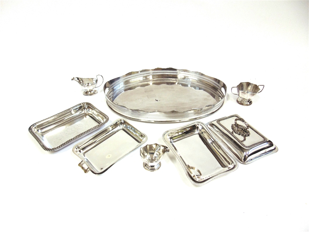 AN OVAL PLATED GALLERY TRAY 62cm long; a pair of entre dishes; and other items