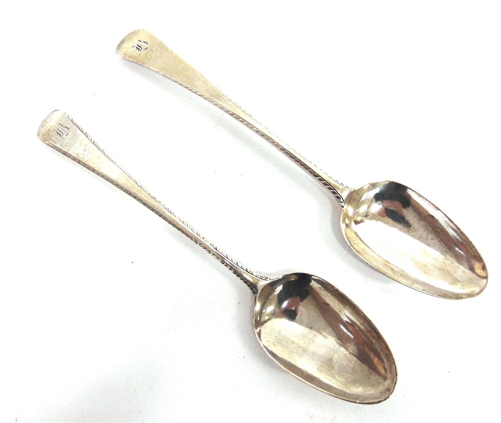 A MATCHED PAIR OF GEORGE III SILVER TABLESPOONS both London 1775, different maker, feather edge