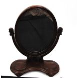 A VICTORIAN MAHOGANY TOILET MIRROR with carved decoration, the base fitted with two hinged