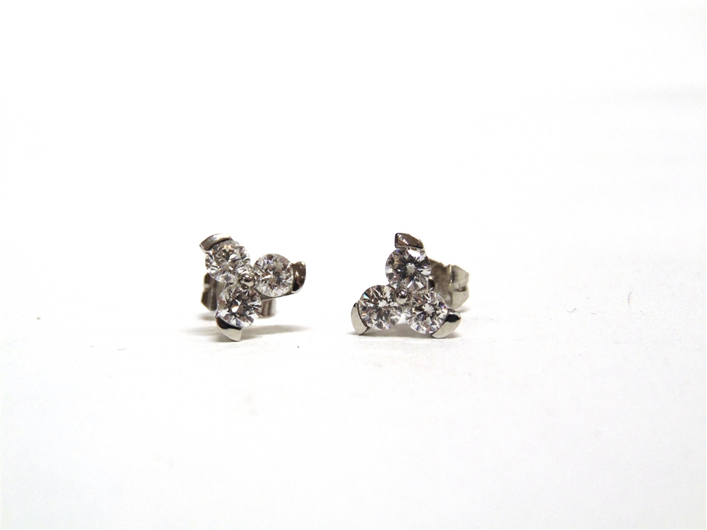 A PAIR OF THREE STONE DIAMOND EARSTUDS of trefoil design, the six modern brilliant cuts totalling