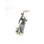 A LARGE LLADRO FIGURE OF A LADY walking a dog whilst holding a parasol, 43cm high