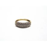 A 9 CARAT GOLD TWENTY NINE STONE DIAMOND DRESS RING the brilliant cuts totalling approximately 0.