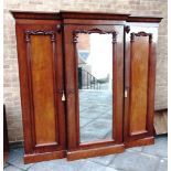 A VICTORIAN MAHOGANY BREAKFRONT COMPACTUM the central mirrored door enabling three sliding trays