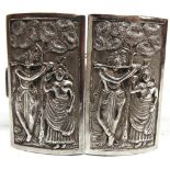 AN INDIAN TWO PIECE METALWARE BELT BUCKLE of rectangular outline, embossed with figures, 7.5cm
