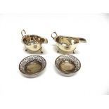 A PAIR OF SILVER SAUCEBOATS Birmingham 19 , of cut rim form with flying handle, on three supports,