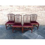 A SET OF FOUR 19TH CENTURY MAHOGANY DINING CHAIRS with red drop-in seats, on slightly tapering