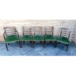 A SET OF FIVE REGENCY MAHOGANY DINING CHAIRS with inlaid crest rails, upholstered stuff over seats