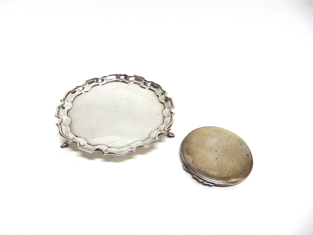 A SILVER CARD SALVER makers mark worn, London 1942, with moulded shaped rim and on three supports,