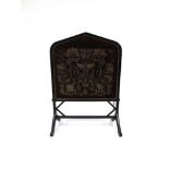 A VICTORIAN GOTHIC REVIVAL FIRE SCREEN with carved ebonised frame, 70cm wide 96cm high