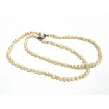 A TWO ROW CULTURED PEARL NECKLACE the sixty-one and fifty-seven pearls of approximately 5.8mm