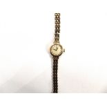 OMEGA, A LADY'S 9 CARAT GOLD MECHANICAL BRACELET WATCH circular white dial with gilt batons and