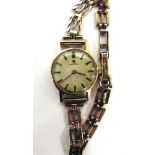 OMEGA, A LADY'S 9 CARAT GOLD MECHANICAL WRISTWATCH the white textured dial with gilt black batons