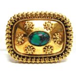 A BROOCH stamped '750', the rectangular panel set with a turquoise matrix cabochon, 4.2cm long, 13.