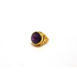 AN AMETHYST DRESS RING unmarked, the round cut stone of approximately 15mm diameter, finger size