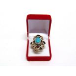 A TURQUOISE AND GARNET AUSTRO HUNGARIAN RING of large proportions, in unmarked silver coloured