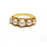 A LATE VICTORIAN FIVE STONE PEARL RING unmarked, the graduated pearls (untested and unwarranted)